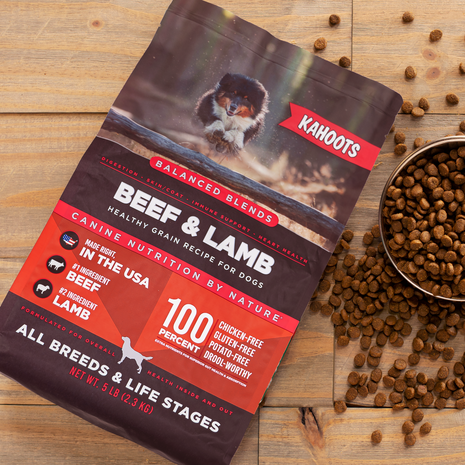 beef and lamb dog food bag against wooden background with kibble spilling out of a bowl