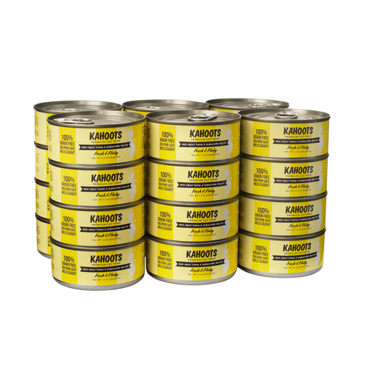 Case quantity of Red meat tuna and albacore wet cat food can. White cat over a yellow stripe background