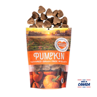 Grain free, heart-shaped pumpkin flavored dog biscuits pouring out of bag