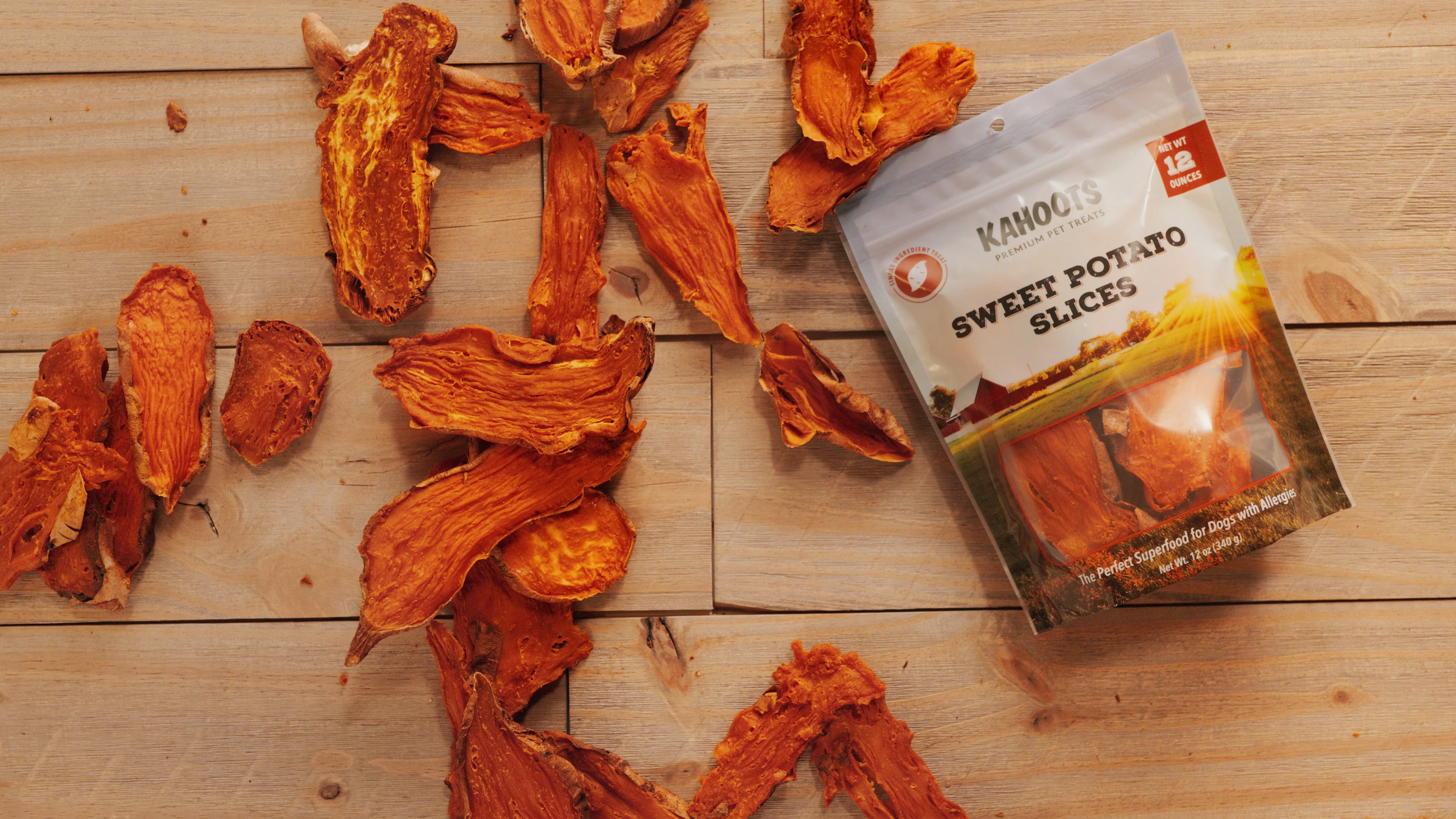 Kahoots sweet potato slices spread out on wood background