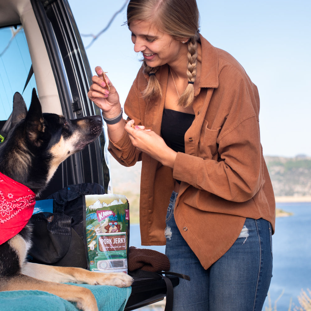 image of woman giving her dog the pork jerky treat