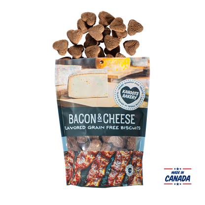 Grain free, heart-shaped bacon and cheese flavored dog biscuits pouring out of bag