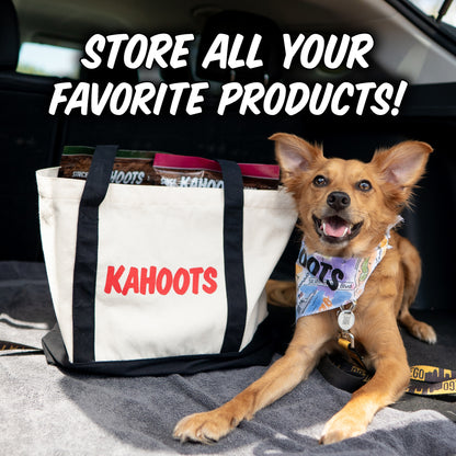 A small tan dog wearing a Kahoots bandana lies in the back of a car next to a large white tote bag with black handles and red Kahoots branding. Large white text at the top reads 'STORE ALL YOUR FAVORITE PRODUCTS!'.