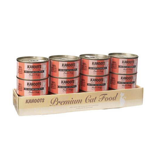 Case quantity of Red meat ahi tuna wet cat food can. White cat over a cream stripe background