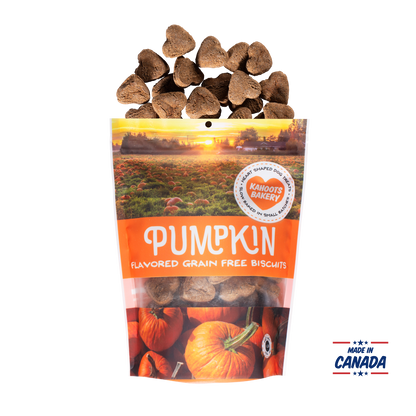 Grain free, heart-shaped pumpkin flavored dog biscuits pouring out of bag