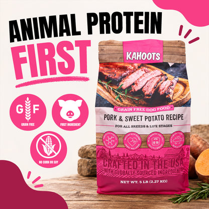 A bag of KAHOOTS Animal Protein First grain free dog food, Pork & Sweet Potato Recipe, displayed on a rustic wooden surface with promotional text and icons on a white background.