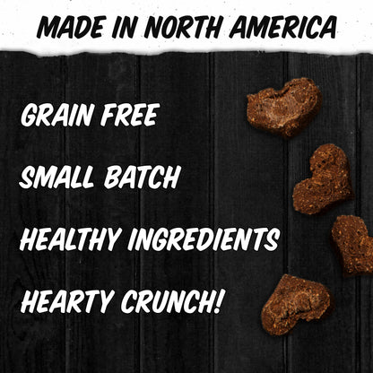 biscuits against a black wood background. "made in North America, grain free, small batch, healthy ingredients, hearty crunch"