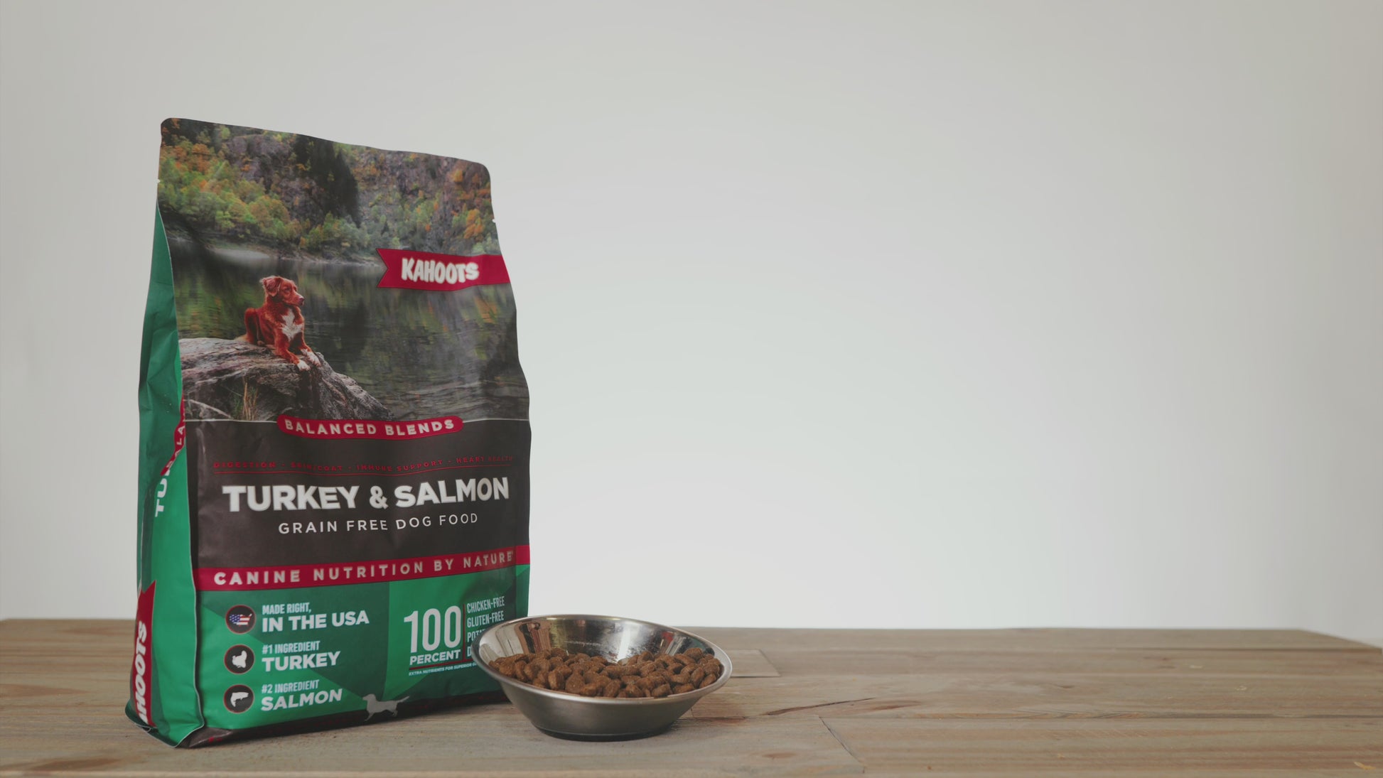 Dog eating turkey & salmon balanced blend dog food out of a bowl with product in background